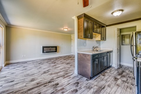the kitchen is open to the living room with a stove and a sink